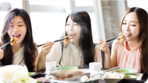 three women eating hotpot