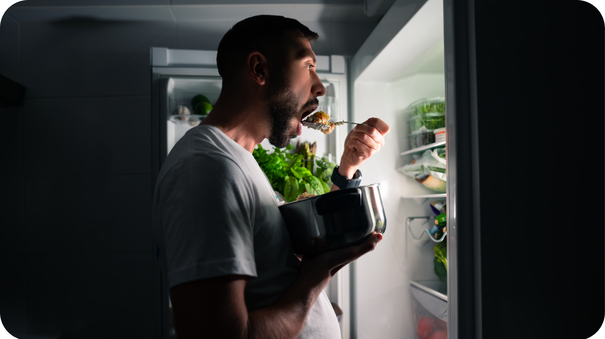 young man eating food at night