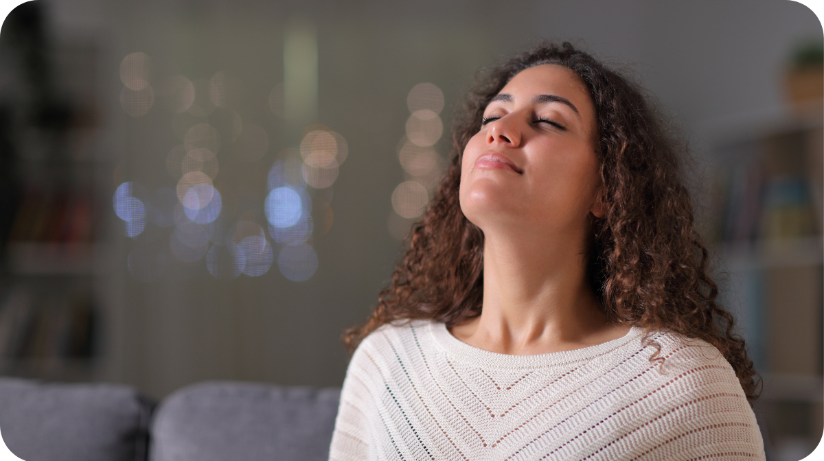 woman with closed eyes, breathing in